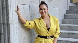 Wearing black biker shorts Chiquis Rivera dances in her kitchen before starting to clean