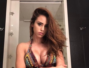 The girl of the weather, Yanet Garcia, poses from behind with a white net minidress and a minimal string thong